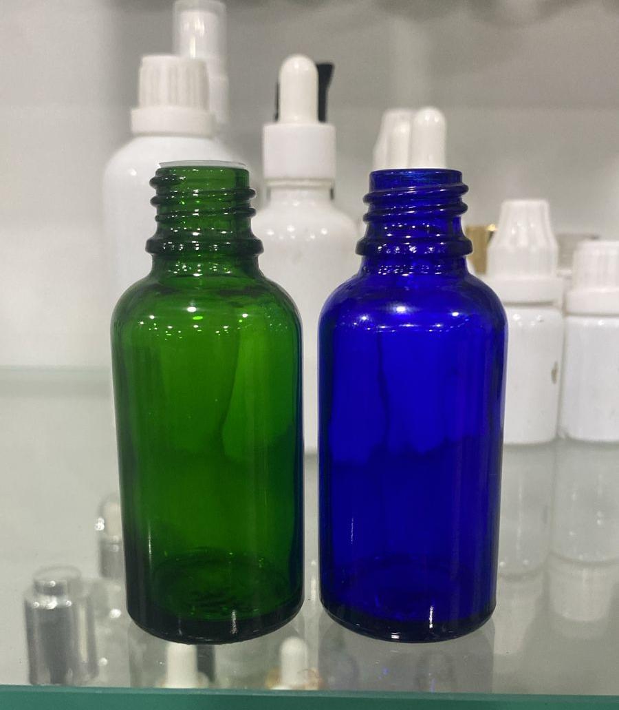 Green and blue glass dropper bottle